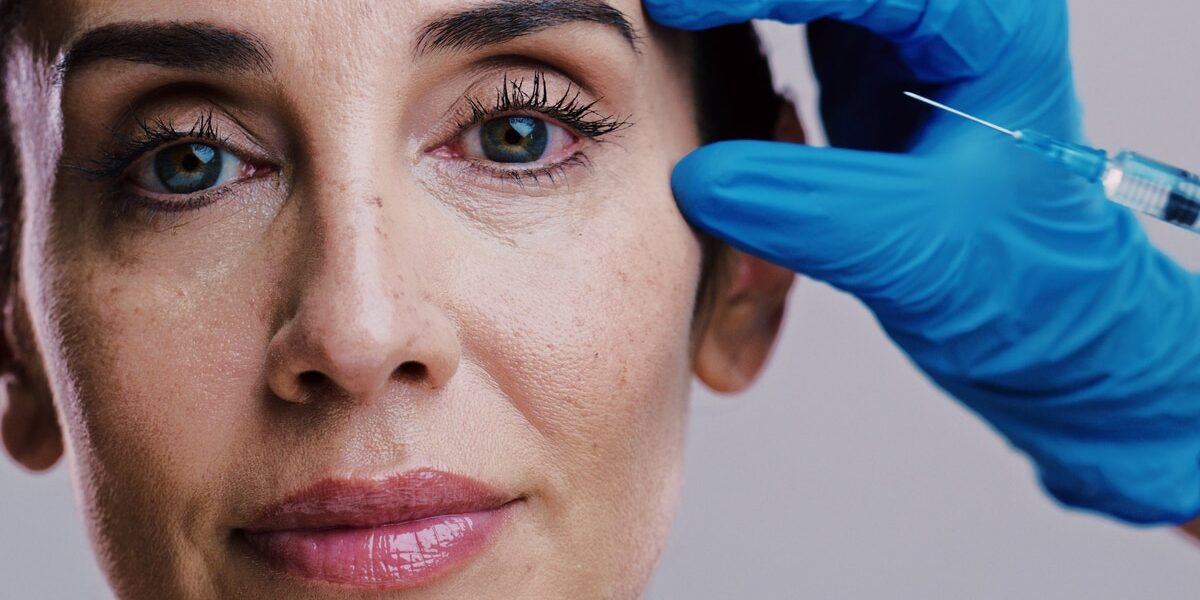 Model, skincare and needle in studio for plastic surgery